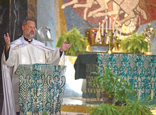 Msgr. Jason Gray, a priest of the Diocese of Peoria, Ill., gives a reflection on Aug. 9 at St. Rita Church in Indianapolis during the annual convocation of archdiocesan seminarians. The priest, who has been highly involved in the beatification and canonization cause of Archbishop Fulton J. Sheen, spoke during the convocation about the insights of the late archbishop, who died in 1979. (Photo by Sean Gallagher)