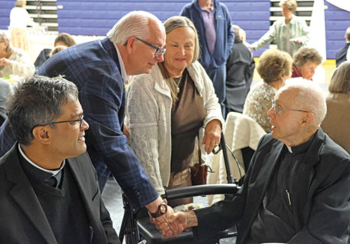 Retired Father John Luerman, right, speaks on May 3 with Tony and Donna Talbert during a celebration of the 70th anniversary of Father Luerman&rsquo;s priestly ordination. The celebration took place at St. Elizabeth Ann Seton Parish in Richmond. The faith community&rsquo;s administrator, Father Sengole Gnanaraj, is at left. (Submitted photo)
