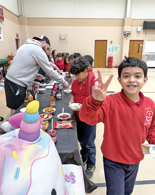When last year&rsquo;s third-grade students at St. Anthony School in Indianapolis finished their Indiana Reading Evaluation and Determination (IREAD) testing, they were rewarded for their preparation with an ice cream party. Then-third-grade student Erick Ochoa Ochoa flashes the peace sign after getting his ice cream. (Submitted photo)