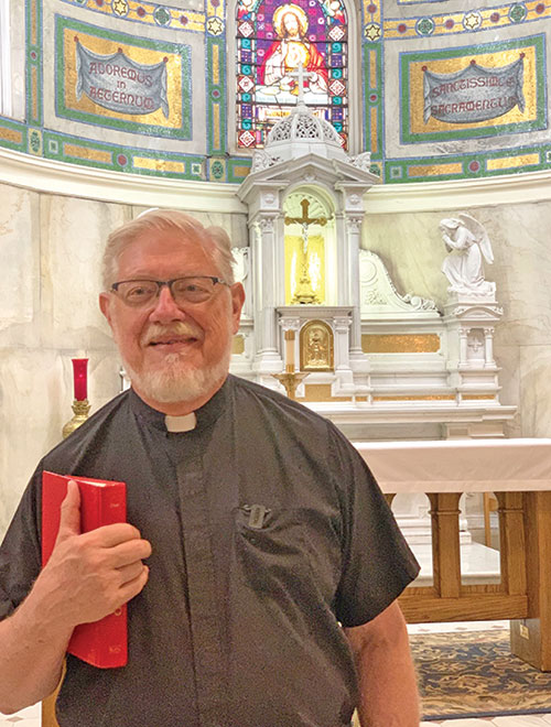 Father Rick Ginther prepares to share his vocal gifts in singing &ldquo;At the Name of Jesus&rdquo; in the Blessed Sacrament Chapel at SS. Peter and Paul Cathedral Parish in Indianapolis (Photo by John Shaughnessy)