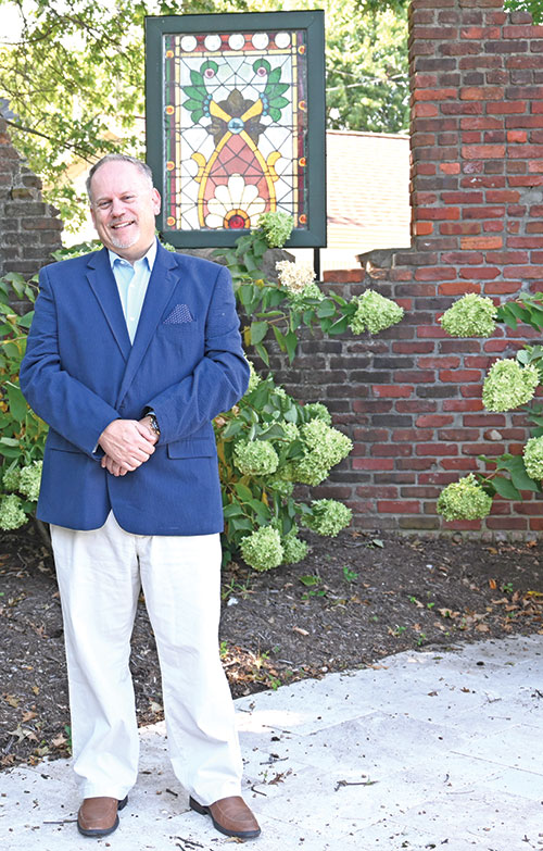 Christopher Haulter, the new agency director of St. Elizabeth Catholic Charities in New Albany, poses on Sept. 4 in Holy Trinity Park, a community green space created by the agency next to its administration building. (Photo by Natalie Hoefer)