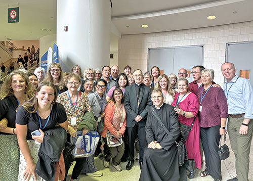 Archbishop Charles C. Thompson (center) poses on Sept. 24 with Father Jonathan Meyer and members of the four parishes Father Meyer serves in Dearborn County before the beatification Mass for Archbishop Fulton J. Sheen at The Dome at America&rsquo;s Center in St. Louis. (Submitted photo)