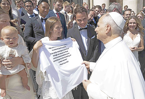 Following their wedding on August 16, 2025, in Immaculate Heart of Mary Church in Indianapolis, Megan and Wes Short spent part of their honeymoon at the Vatican, taking part in a general audience with Pope Leo XIV in which he blessed recently married couples. As Megan wore her wedding dress and Wes his tuxedo, the couple presented the pope with a shirt from the JP Flag Football League in Indianapolis, a T-shirt that featured a quote from the pope during the Jubilee of Sport in 2025. (Submitted photo)
